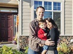 Family of 3 infront of a house