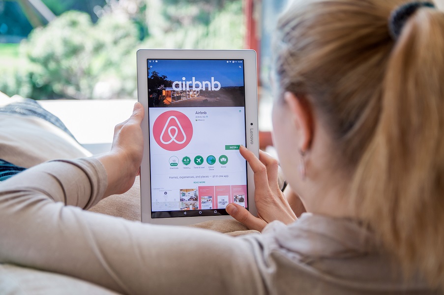 Woman scrolling on airbnb