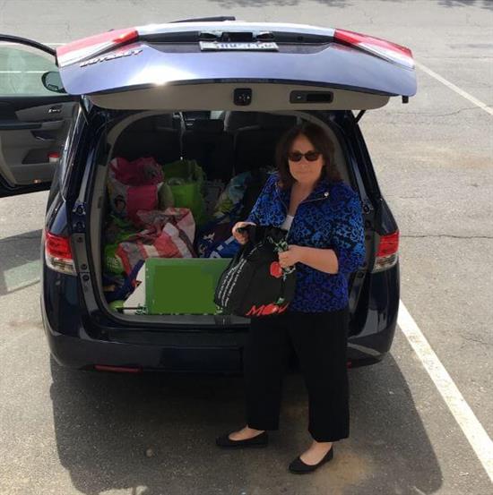 A realtor with gift donations in her trunk